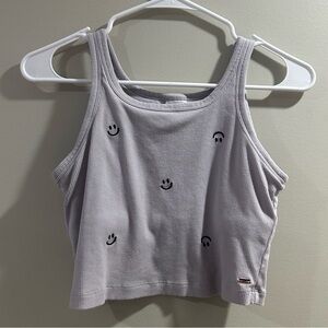 Purple smile face tank top, it is kind of cropped.